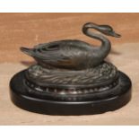 A 19th century dark-patinated bronze, of a swan on the water, oval Noir Belge base, 11cm wide