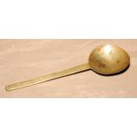 An 18th century brass spoon, 24cm long