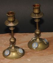 A pair of 19th century jasperware mounted brass candlesticks, the cabochons sprigged in the Grand