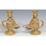 A pair of 19th century gilt brass novelty candlesticks, cast as boars’ heads, looped tail handles,
