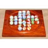 A 19th century mahogany double-sided solitaire board, 15.5cm wider, marbles en suite