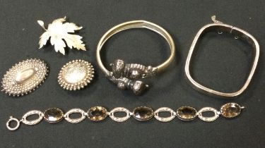 Jewellery - silver rounded square hinge bangle, leaf and other brooches, Scottish smoky quartz