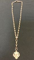A 9ct gold fancy link double Albert chain, suspending a 9ct gold medal, stamped 375 9, Birmingham