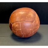 An early 20th century leather Medicine Ball, approx 28cm diameter, 4kg, unnamed.