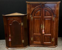 A early 20th century mahogany corner cupboard with three fitted shelves and pair of interior