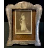 An Edwardian Arts and Crafts silver photograph frame, arched top, easel stand, S Blanckensee & Son