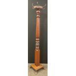 A 20th century coat and hat stand, octagonal four hook top, turned and carved column, square base,