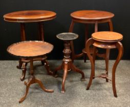 An Edwardian mahogany oval occasional table, four tapering columns, inverted undertier, shaped