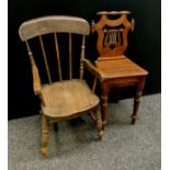 A carved pitch pine lyre back hall chair, bone string detailing, turned fore legs, 79cm high, 44cm