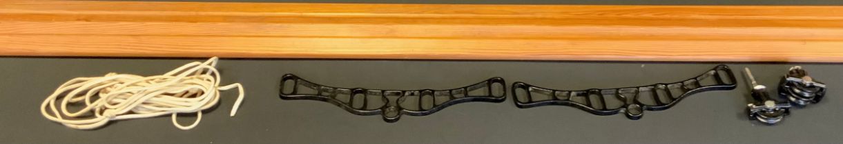 A 20th century clothes airier, black cast iron brackets and rope,180cm long