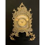 A brass strut clock timepiece and thermometer, by The British United Clock Company, Birmingham, 27cm