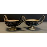 A pair of bronzed coloured metal twin handled censers, cast in relief with trailing vines and grapes