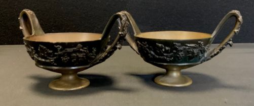 A pair of bronzed coloured metal twin handled censers, cast in relief with trailing vines and grapes