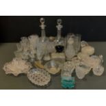 A novelty glass table sat as a railway cart; decanters, drinking glasses, quartered oil bottle