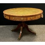 A Regency style 20th century mahogany drum table, with four frieze drawers and four dummy drawers,