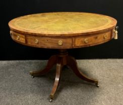 A Regency style 20th century mahogany drum table, with four frieze drawers and four dummy drawers,