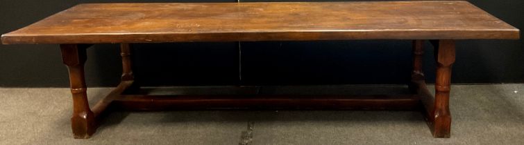 A large 20th century oak refectory table, thick rectangular top, cannon barrel legs, H stretcher,
