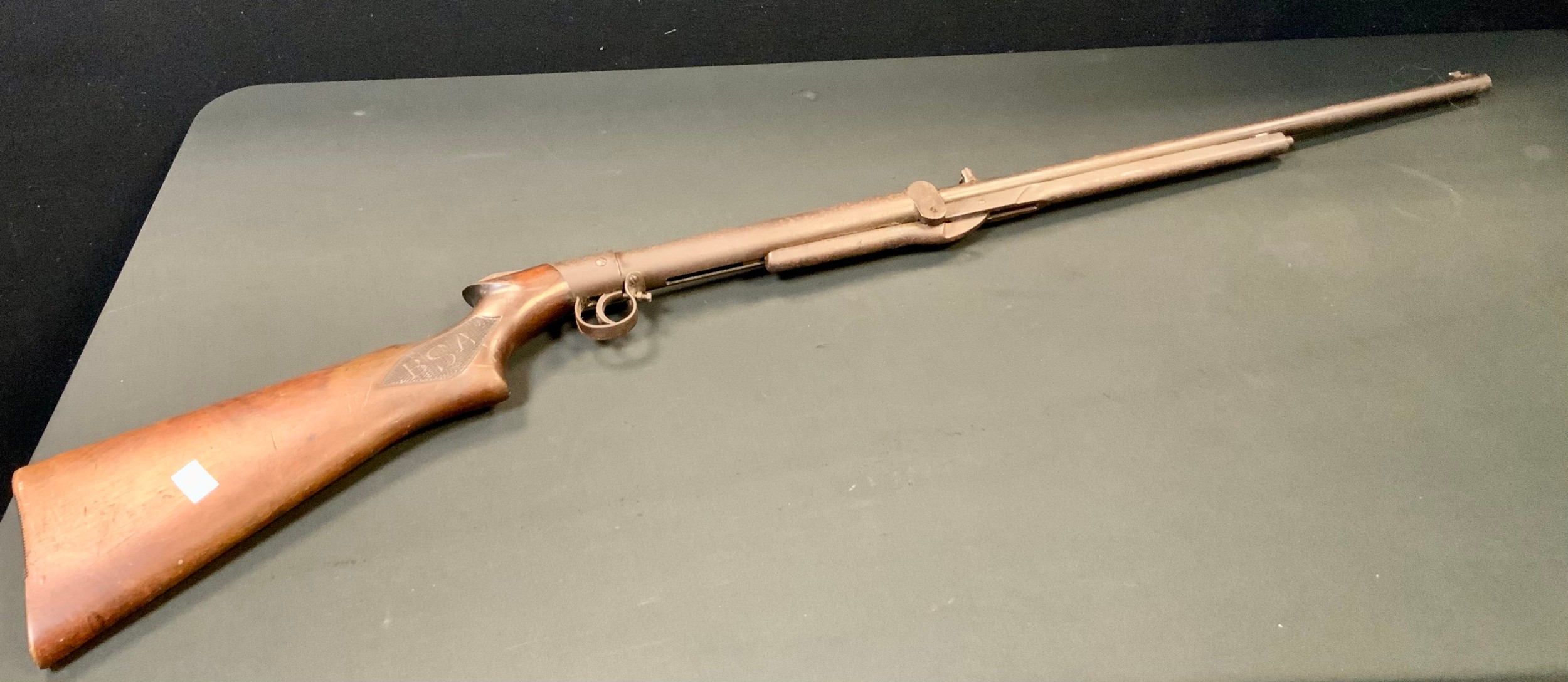 An early 20th century BSA air rifle, .177 calibre, underlever action, walnut stock with chequered