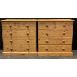 A pair of pine five drawer chests, each with rounded oversailing tops, two short over three long