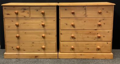 A pair of pine five drawer chests, each with rounded oversailing tops, two short over three long