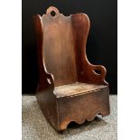 A late 18th century boarded child’s rocking chair/ commode, hinged seat, comprising of various woods