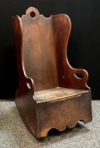 A late 18th century boarded child’s rocking chair/ commode, hinged seat, comprising of various woods