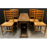 A set of four 19th century elm ladder-back chairs, rush seats, turned legs and stretchers; a