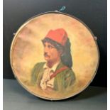 An early 20th century Italian tambourine, painted with a portrait of a gentleman, 33cm diam,