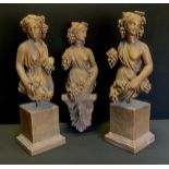 A pair of Greco Roman style figures, Girls with Grapes and Flowers, similar wall plaque, (3)