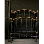 A Victorian cast iron and brass double bed frame.