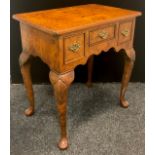 A reproduction burr elm lowboy, oversailing top above three frieze drawers, shaped apron, shell