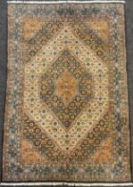 A Persian Moud rug, hand-knotted, hexagon-shaped medallion, in subdued tones of blue, red, and