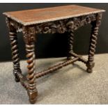 A 19th century Jacobean style carved oak centre table, over-sailing top, carved lip, carved to all
