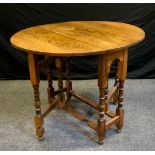 A oak double drop leaf gate leg table, 20th century. 75cm high x 83cm wide x 100cm deep