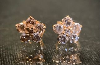 A pair of diamond cluster earrings, each set with six round brilliant cut diamonds, total