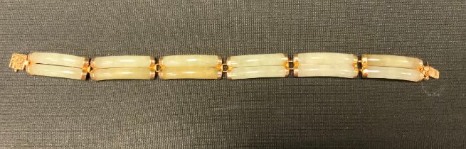 A Chinese pale jade green stone double bar link bracelet, Chinese character clasp, stamped 585