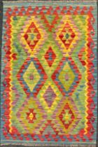 A Turkish Anatolian Kilim rug, knotted in bright colours, with a repeating geometric pattern, in