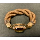 A 19th century hair work bracelet, triple strand links, yellow metal clasp with a central deep