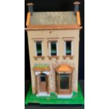 A 20th century two story dolls house with fitted interior including furniture and appliances. 38cm