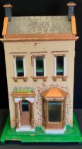 A 20th century two story dolls house with fitted interior including furniture and appliances. 38cm