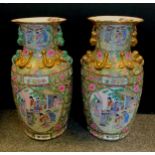 A pair of large Chinese famille rose floor vases, figural panels within intricate floral ground,