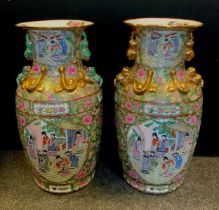 A pair of large Chinese famille rose floor vases, figural panels within intricate floral ground,