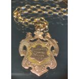 A 9ct gold shield medal pendant necklace, Slaithwaite Prize 1909, 20.6g gross