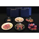 Moorcroft Pottery - six circular dishes, each in a different pattern including Frangipani, Oberon,