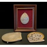 A Mother of pearl carved shell inscribed Assunzione DIMV, framed; pierced mother of pearl shell