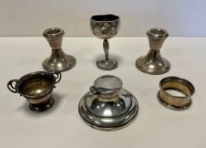 A pair of silver squat form filled candlesticks, weighted bases, similar inkwell, twin handled