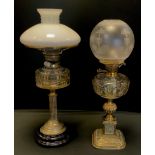 A late Victorian brass Corinthian column table oil lamp, adjustable burner, clear glass reservoir,