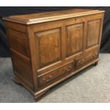 A 19th century oak Lancashire mule chest, walnut cross-banded top, three-panel front, above pair