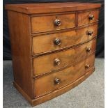 A Victorian mahogany bow-front chest of drawers, having a pair of short, above three graduated