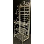 A set of white painted wrought iron folding shelves, shallow graduated two tiers, three full